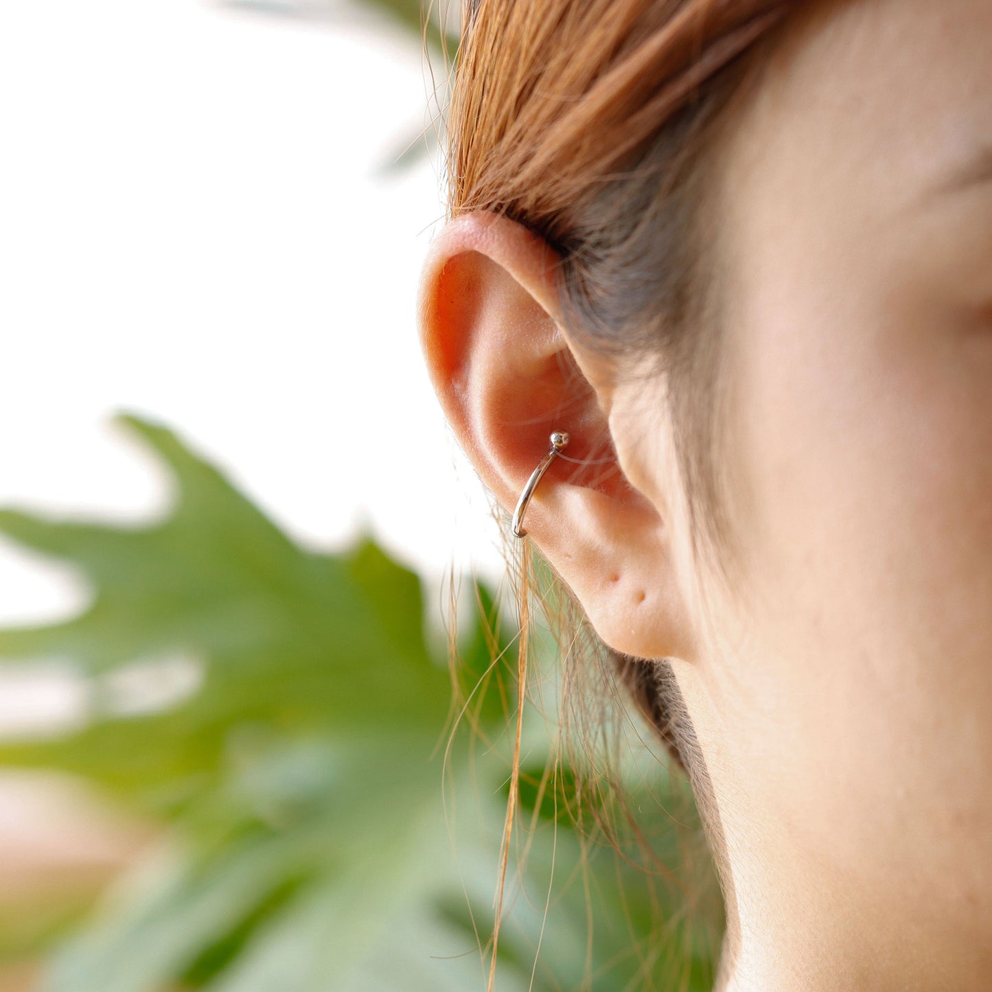 Sterling silver conch hoop piercing worn on ear, minimalist and everyday style.