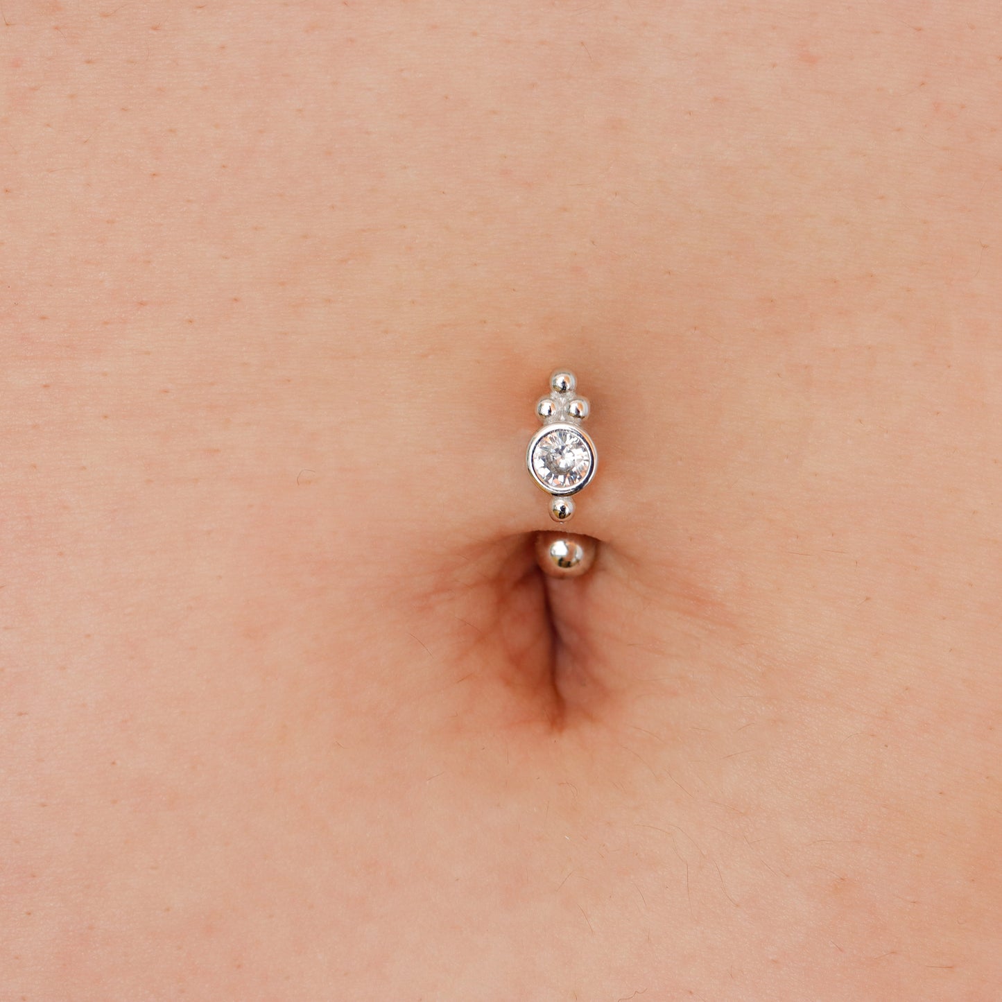 Floating navel ring in sterling silver, designed for a subtle and elegant belly piercing.