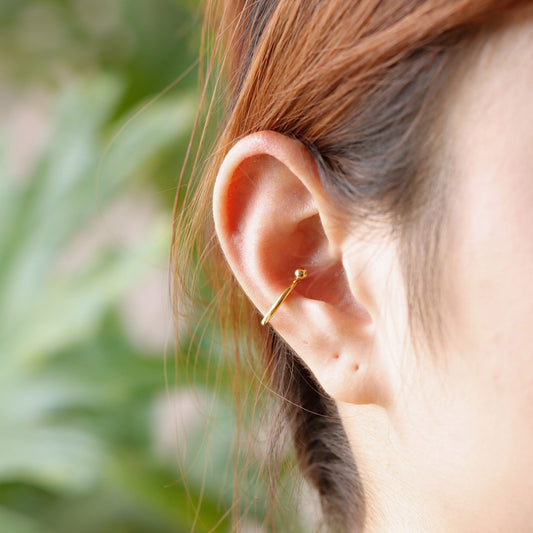24k gold vermeil conch hoop piercing worn on ear, youthful and stylish everyday look.