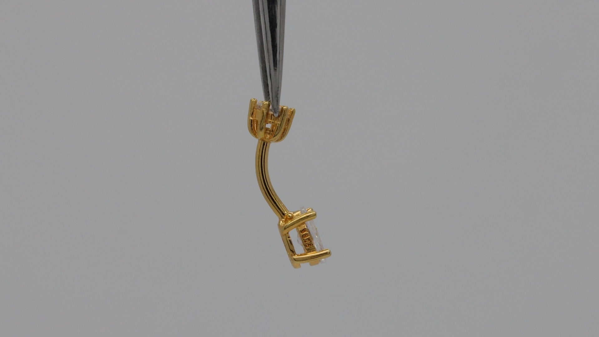 Video demonstration of gold vermeil belly button ring with oval cubic zirconia gemstone showing sparkle and design details