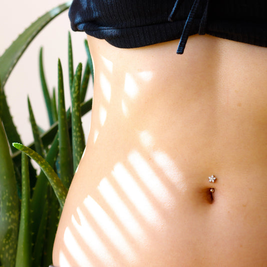 small flower belly button piercing